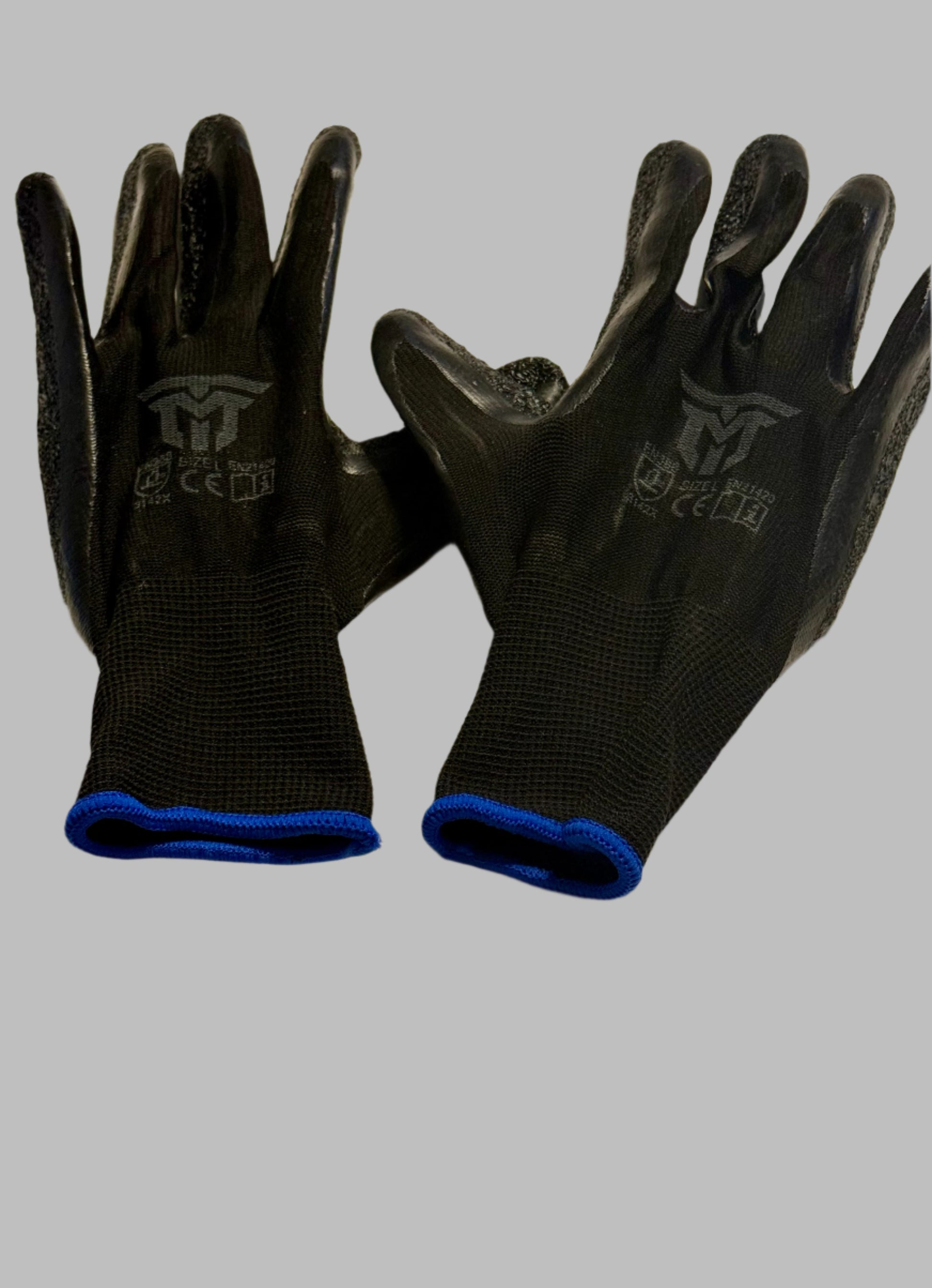 Pair of black gloves with blue cuffs on a light background